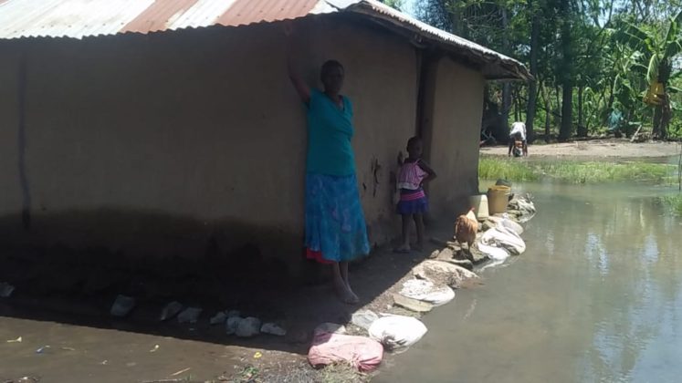 Woman and child in flooded area.