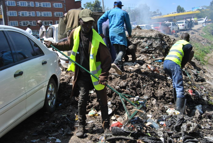 Mwangi cleaning the environment at Grogon in Nairobi