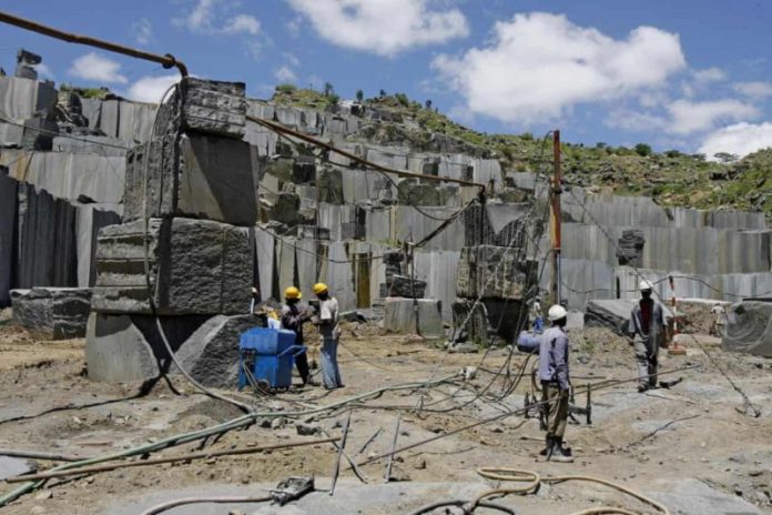 Miners at an open cast Granite mine in Mutoko