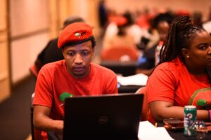 Dumisani Baleni seated in a lecture hall at an EFF Gauteng Provincial Plenum.