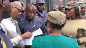 Zandile Dabula, the President of Operation Dudula, with members of the police during one of their many operations in Johannesburg, South Africa.